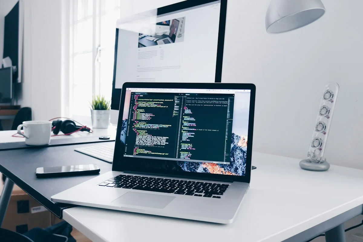 An organised digital workspace with a laptop, notes and planning tools